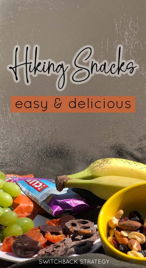 Best foods to bring on day hikes, bananas, apple, green grapes, trailmix, chocolate covered apricots, energy bar on a blanket | switchbackstrategy.com