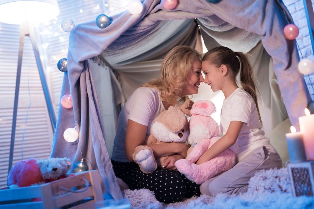 Mom and daughter in a blanket fort