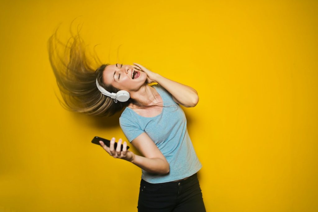 Girl dancing on yellow backdrop