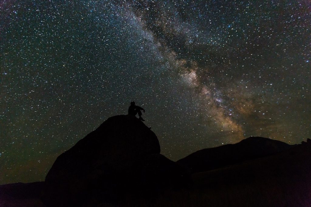 Milky way in starry sky and silhouette on a mountain top